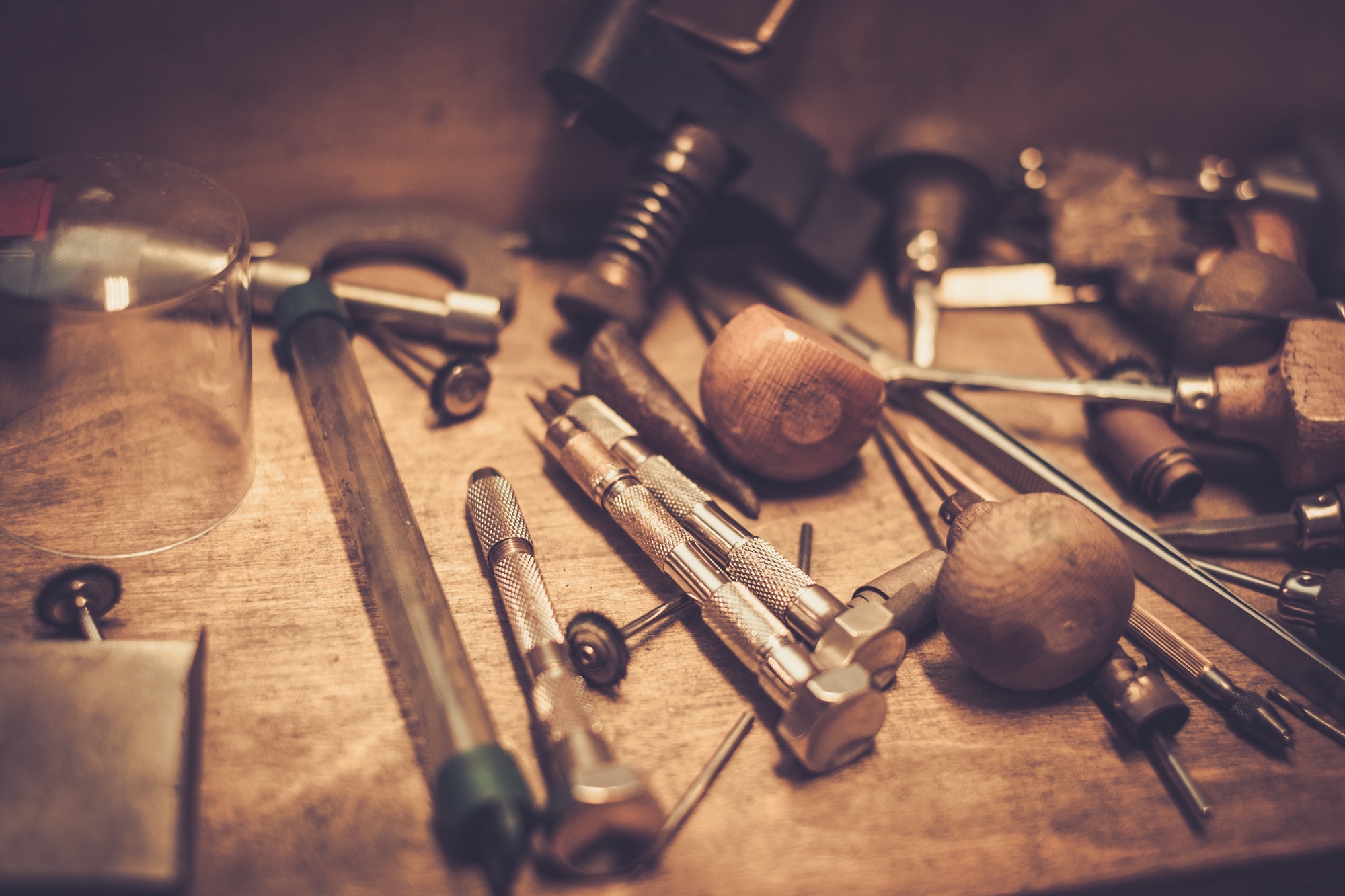 Different goldsmiths tools on the goldsmith workplace.