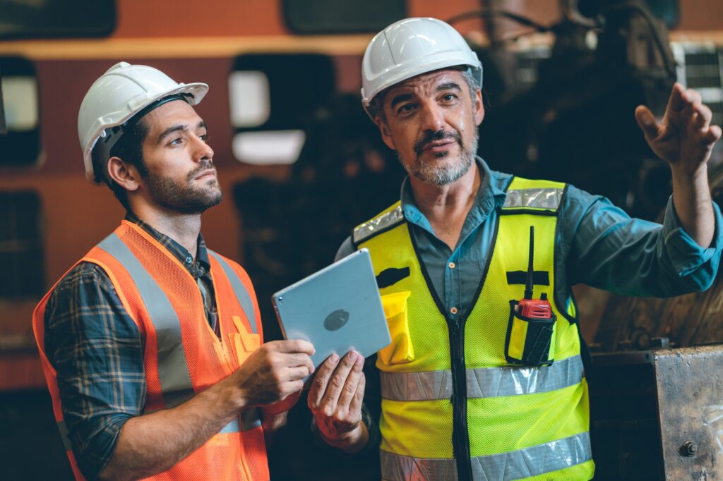 professional technician engineer with safety working in industrial manufacturing factory,