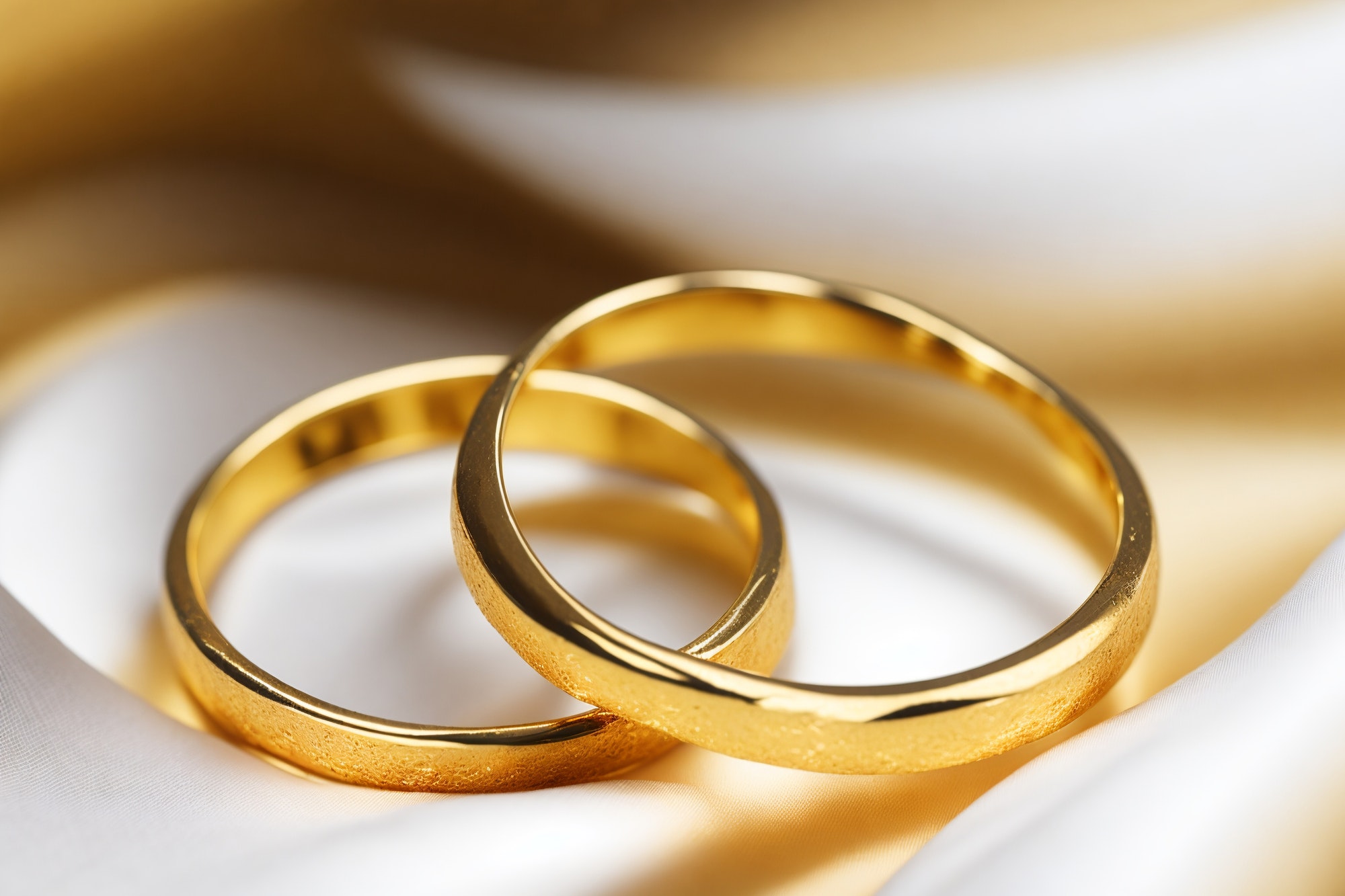 Exquisite Gold Wedding Rings on a Beautiful Silk Cushion