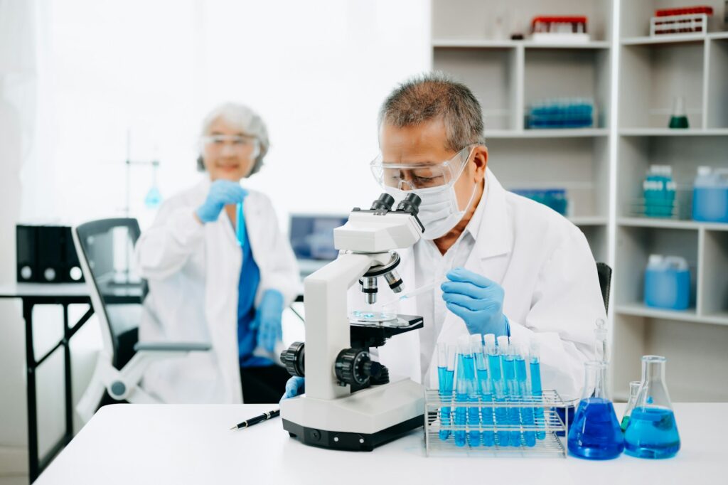Scientist team meeting and writing analysis results in the laboratory