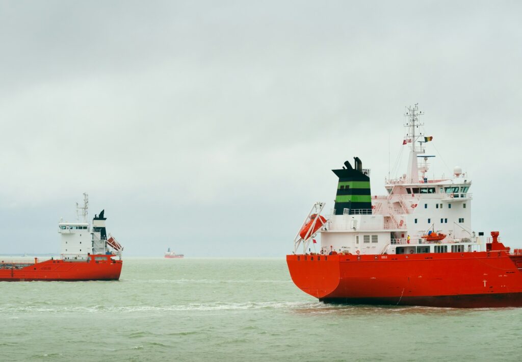 Ships with red hull pass each other on the North Sea