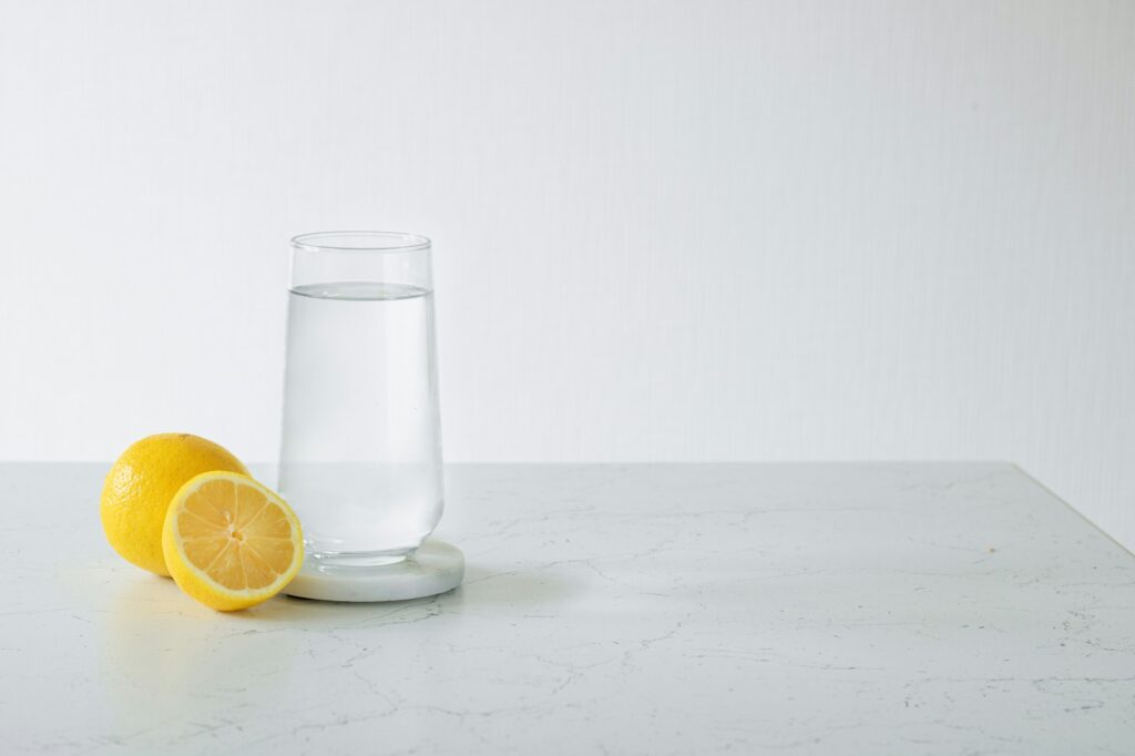 A glass of clean water, next to a fresh lemon. Healthy food concept. Losing weight concept.