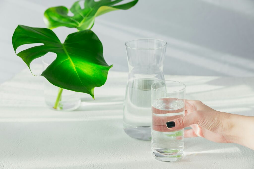 Females hand holds a glass of clean water