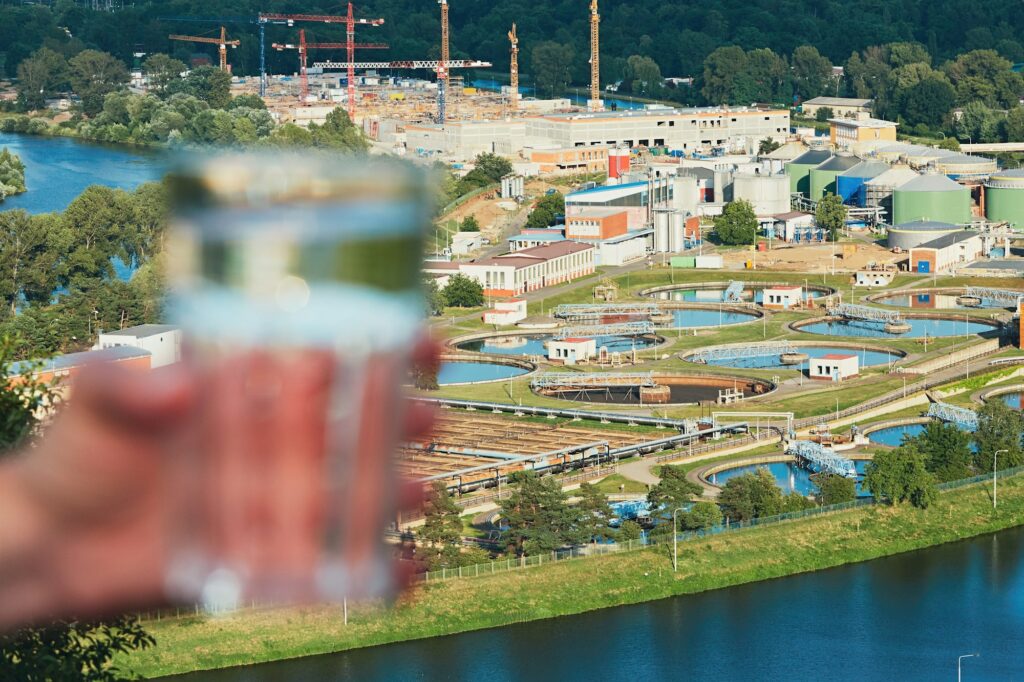 Glass of drinking water and sewage treatment plant